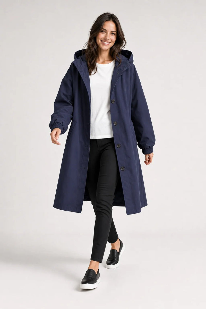 Sofaine Brooklyn long hooded windbreaker coat in navy blue, worn front view mid-step
