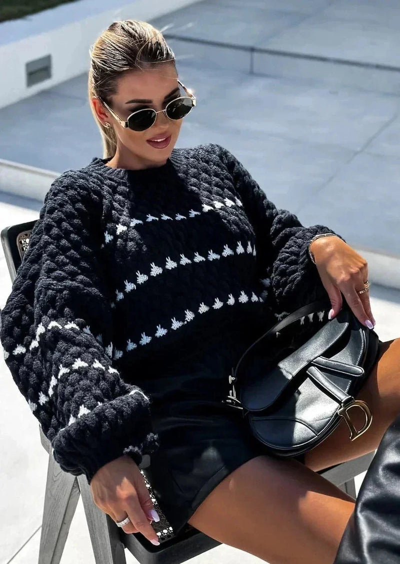 Chunky Knit Sweater for Women with Heart Pattern and Balloon Sleeves in Black, seated view