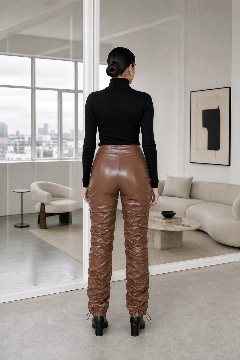 Celeste | Stacked Vegan Leather Pants in Brown, studio back view