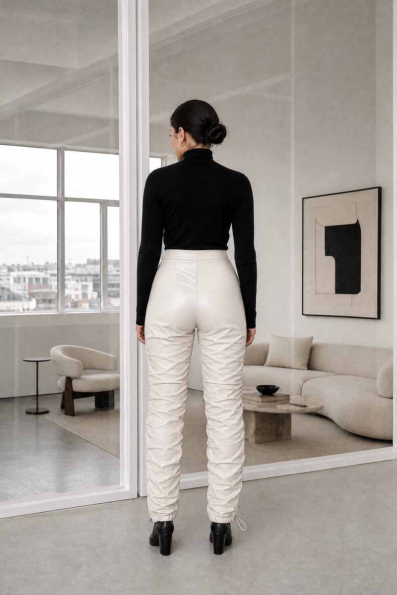 Celeste | Stacked Vegan Leather Pants in Cream, studio back view