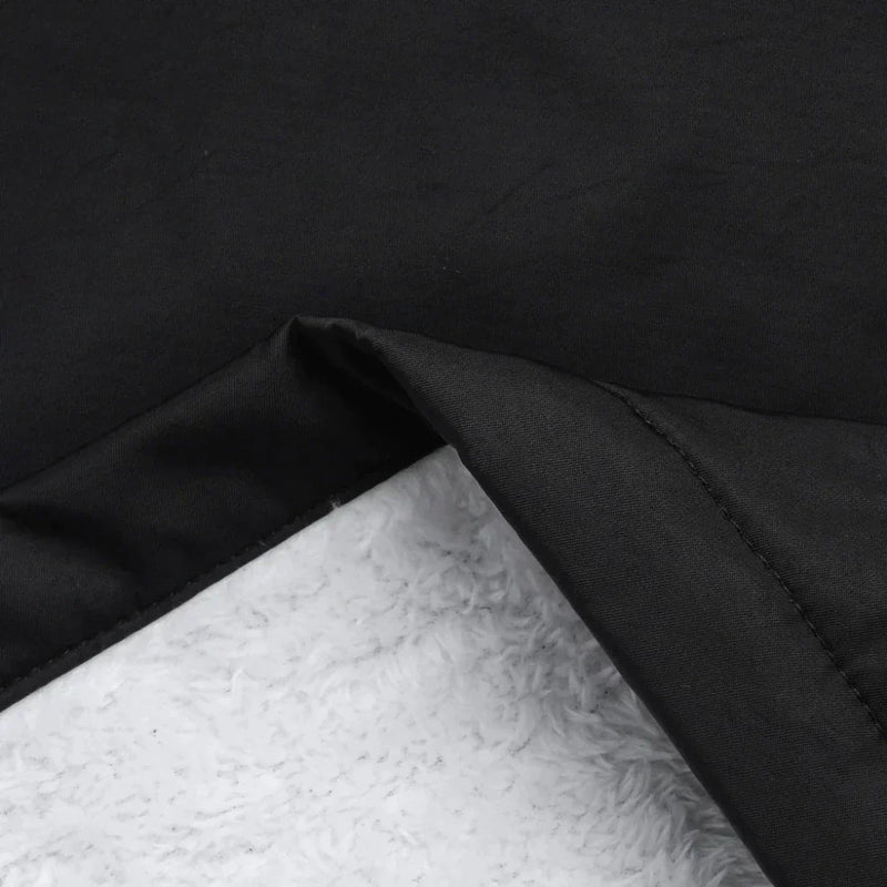 Fleece Lined Waterproof Rain Jacket for Women with Hood and Flap Pockets in Black, fabric close-up with fleece lining