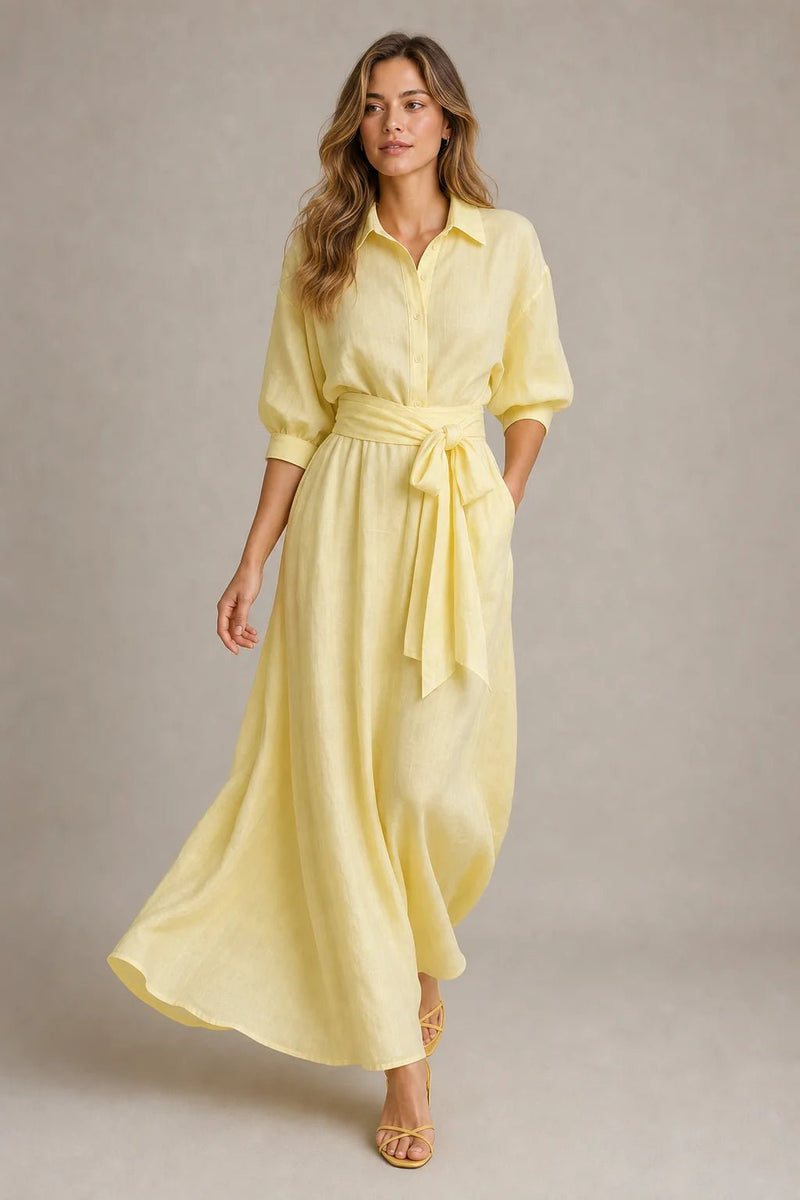 Sofaine Harper pale yellow linen maxi shirt dress worn walking with flowing skirt, front view