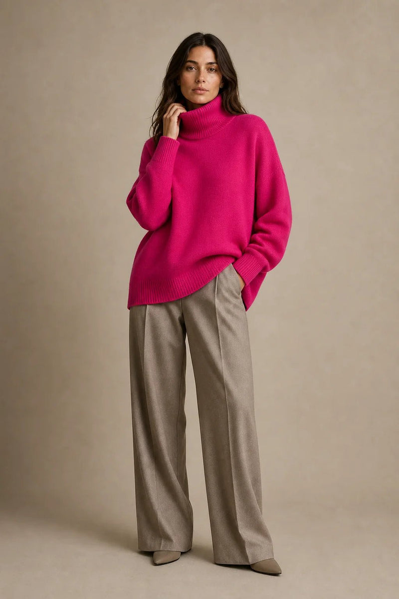 Sofaine Nova oversized knit turtleneck sweater in fuchsia pink, styled full look with taupe trousers