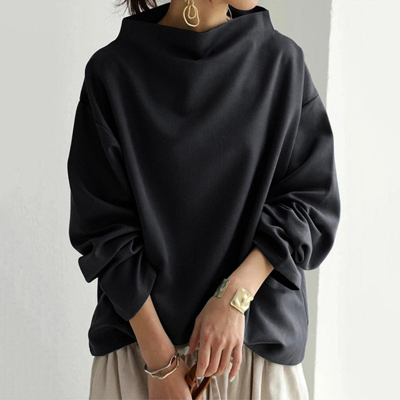Relaxed Mock Neck Top for Women with Dropped Shoulders and Wide Cuffs in Black, styled front view