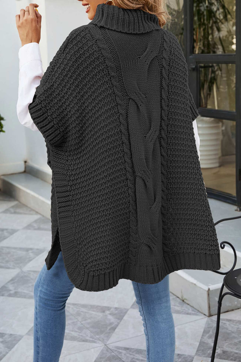 Turtleneck Poncho Sweater for Women with Cable Knit and Side Slits in Black, back view