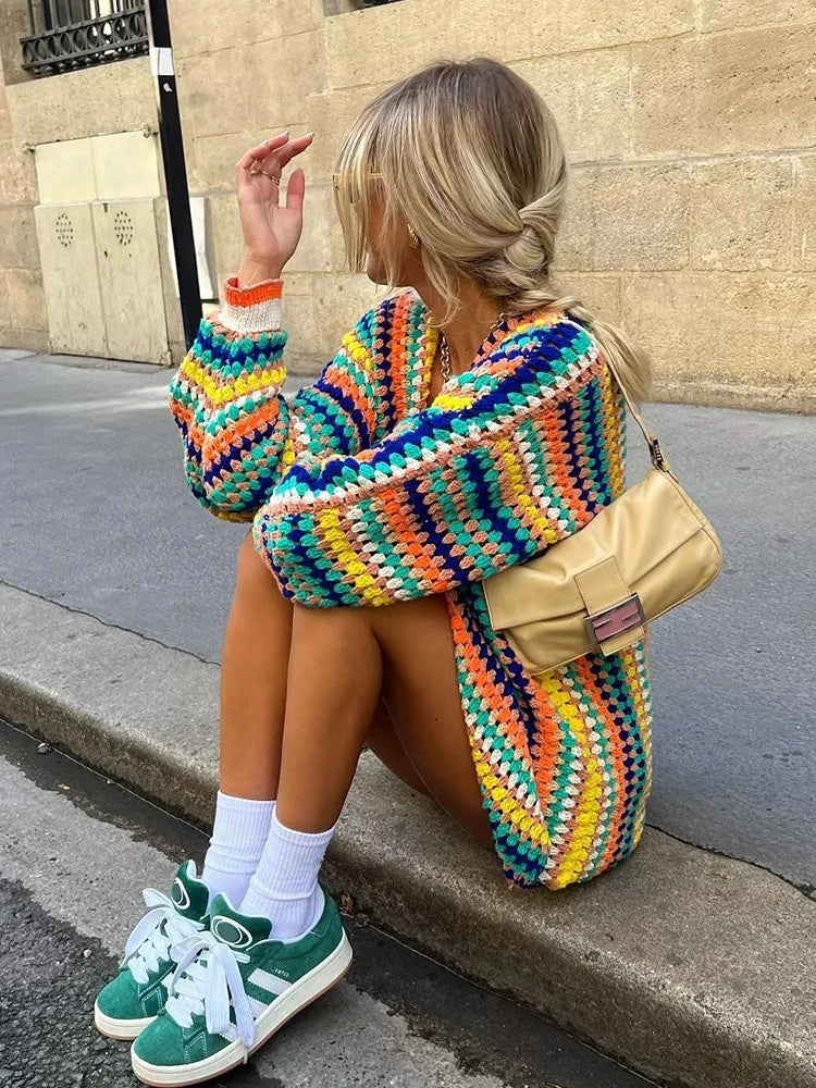 Rainbow Striped Crochet Cardigan for Women with Open Front and Ribbed Cuffs in Multicolor, seated side view